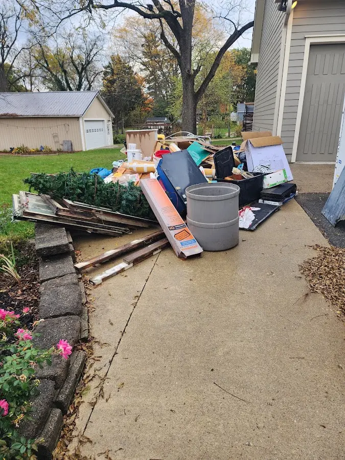 Dumpster being loaded with debris for Estate Cleanout Dumpster Rental in Southfield